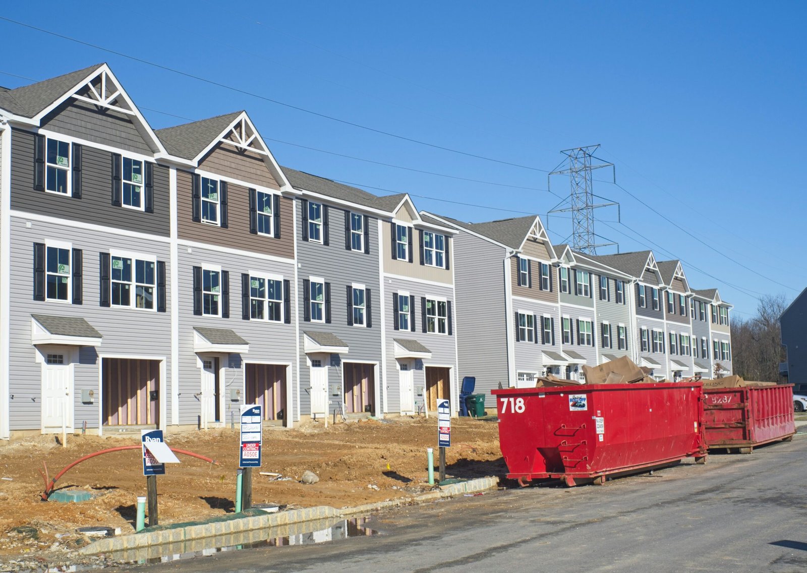 a row of houses with a red truck parked in front of them